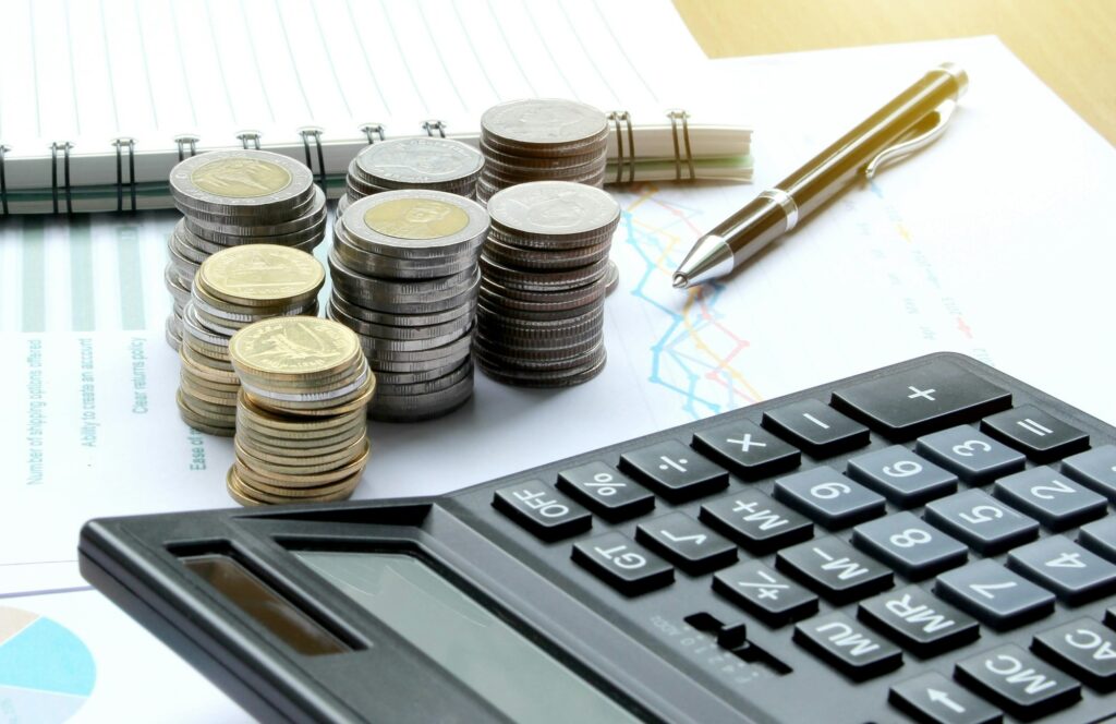Calculator and Coins of thailand on the office desk investment and property for concept
