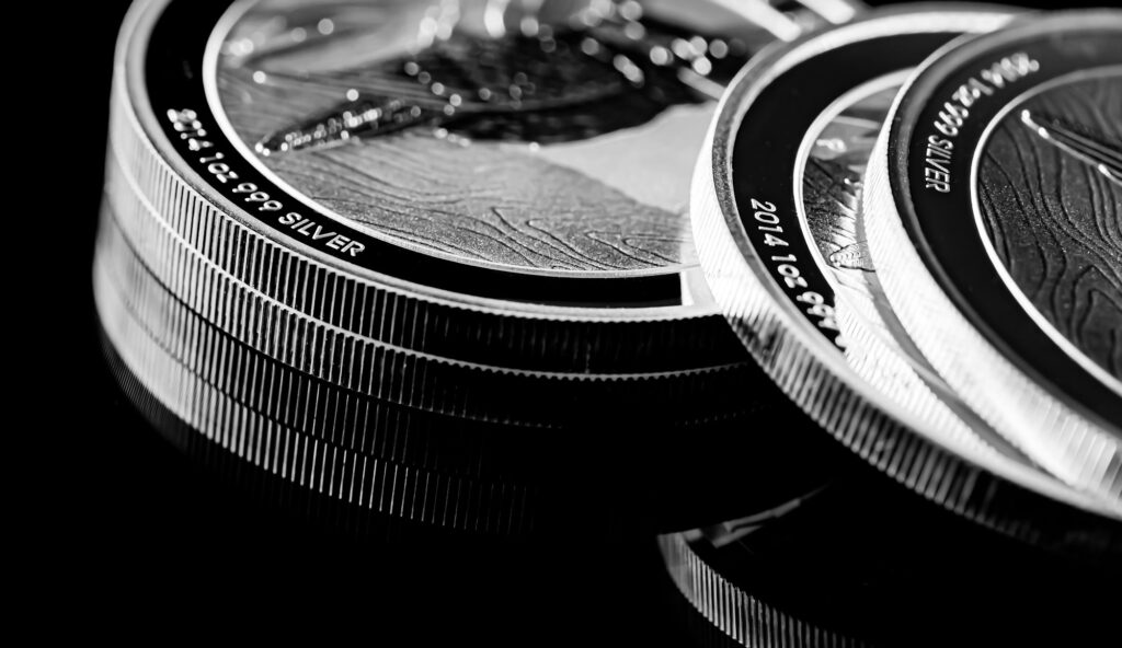 Close up of Silver Bullion Coin on a black mirror background